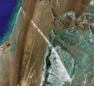 Illustration for article titled The World's Longest Conveyor Belt System Can Be Seen From Space